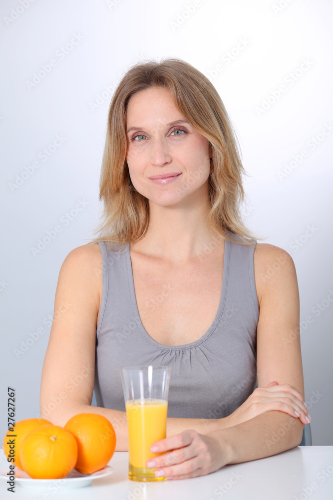 Woman drinking fresh orange juice Woman drinking fresh orange juice