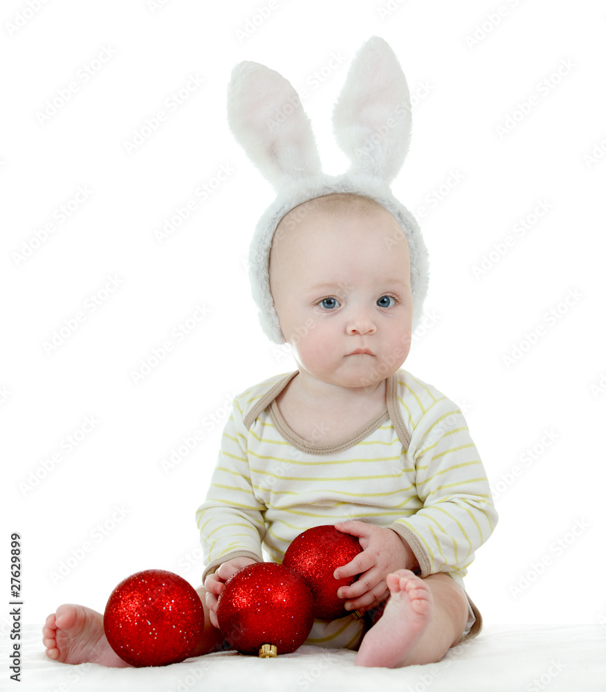 Little child in bunny ears holding new year balls Little child in bunny ears holding new year balls