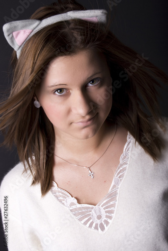Portrait of a young girl looking like a cat