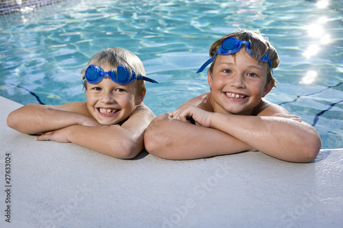 Boys grinning on side of swimming pool © Kablonk Micro