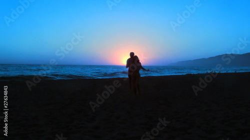 Romantic couple plays on beach at sunset - HD