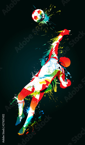 The football goalkeeper catches a ball on the black background
