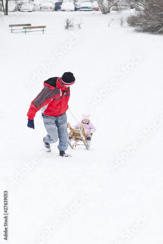 little girl sledding with her daddy © Richard Semik