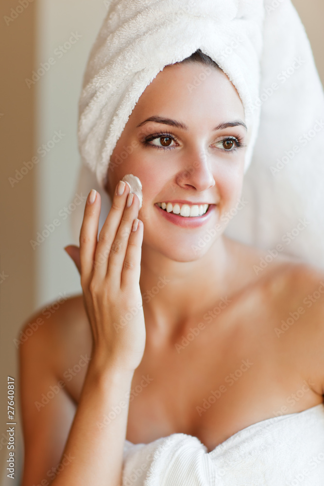 Woman applying lotion Woman applying lotion