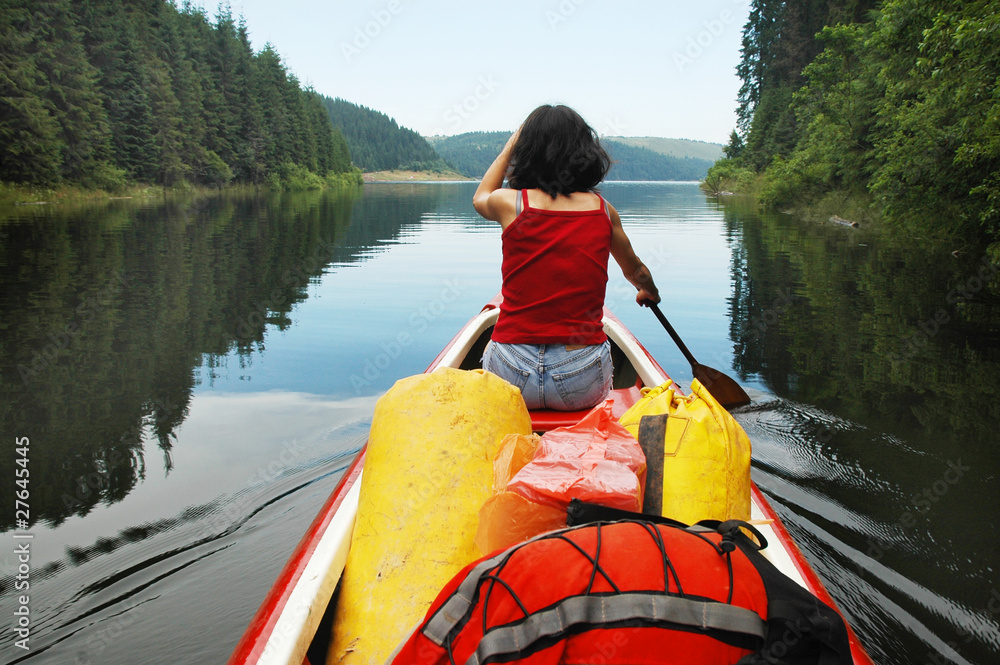 Canoeing girl on a lake