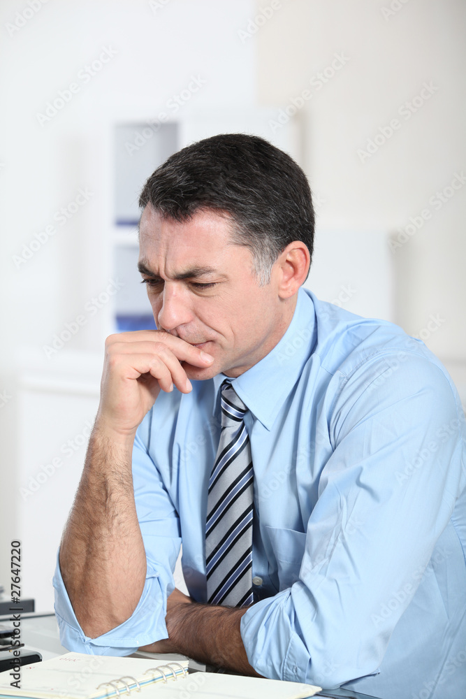 Businessman in the office working hard on project Businessman in the office working hard on project