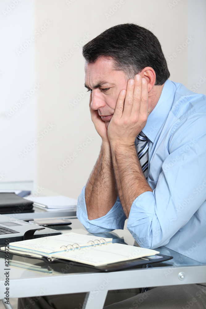 Businessman in the office working hard on project Businessman in the office working hard on project