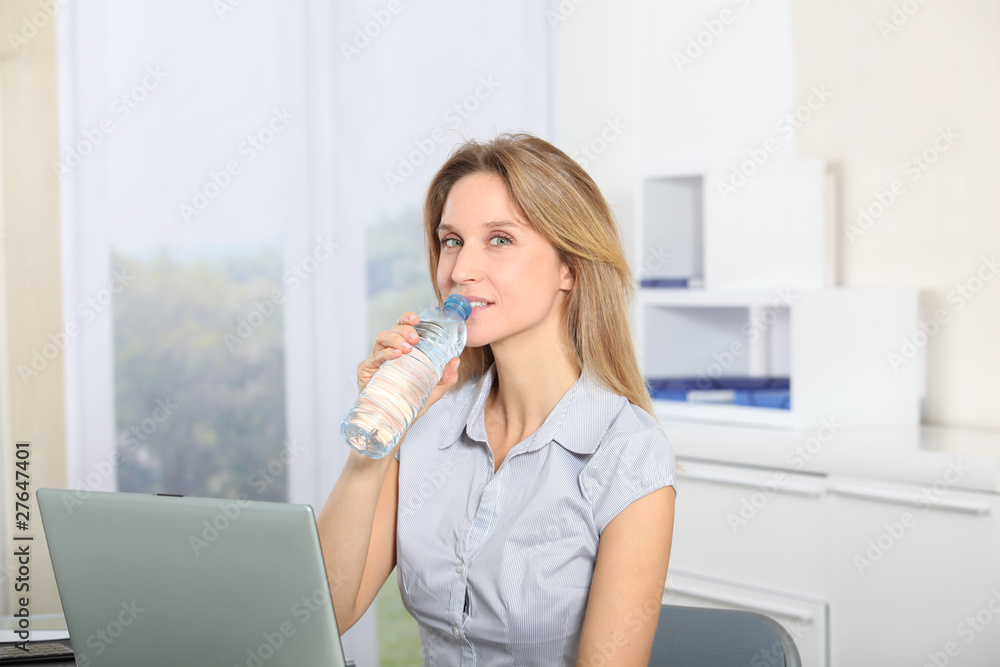 Closeup of beautiful office worker drinking water Closeup of beautiful office worker drinking water