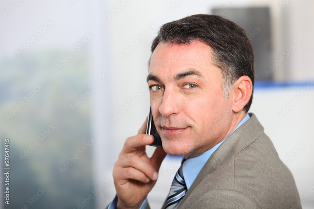 Closeup of businessman talking on the phone Closeup of businessman talking on the phone