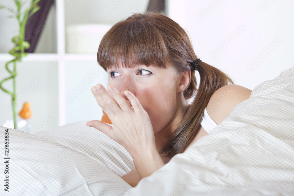 yawning woman in bed yawning woman in bed