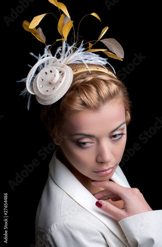 Young woman with bridal hairstyle and a small hat