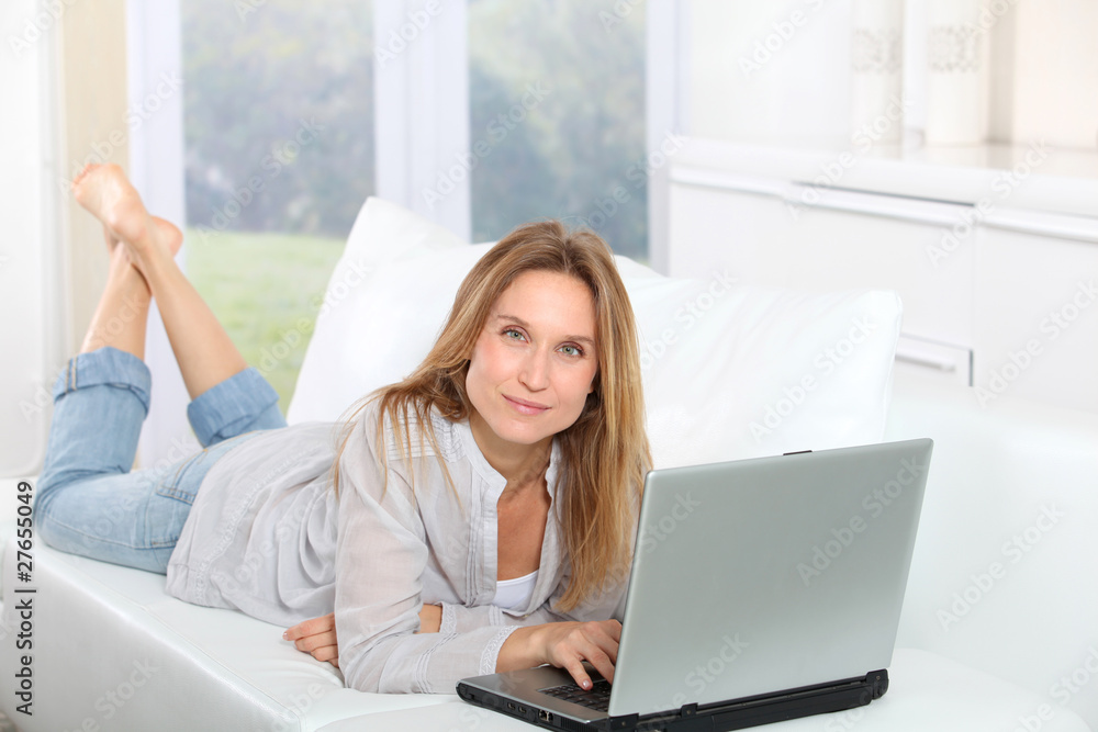 Beautiful blond woman surfing on internet at home Beautiful blond woman surfing on internet at home