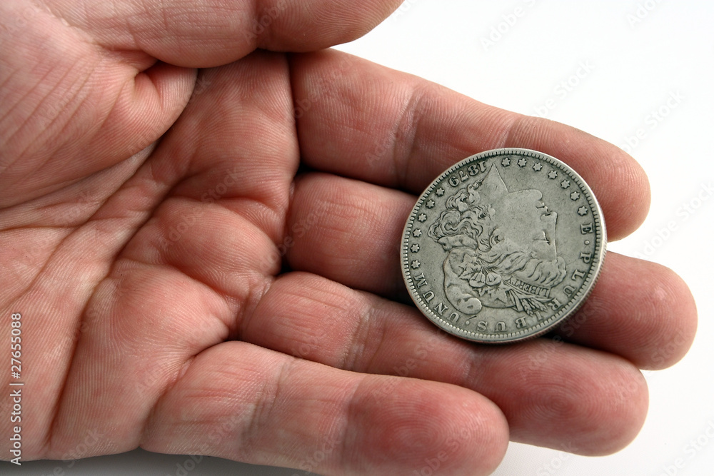 Fototapeta premium hand with dollar silver coin