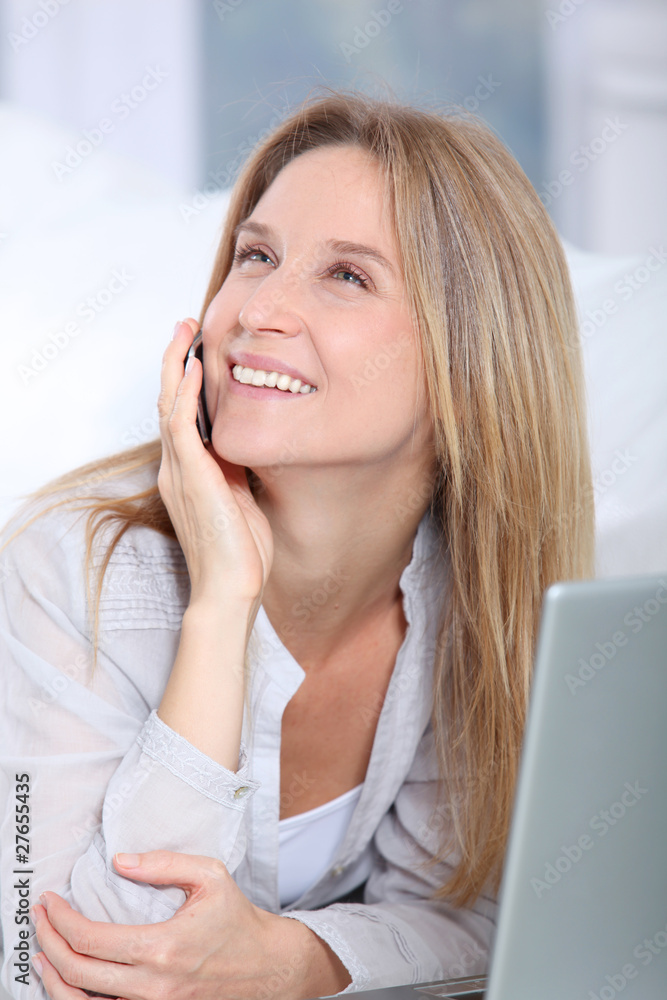 Beautiful blond woman surfing on internet at home Beautiful blond woman surfing on internet at home
