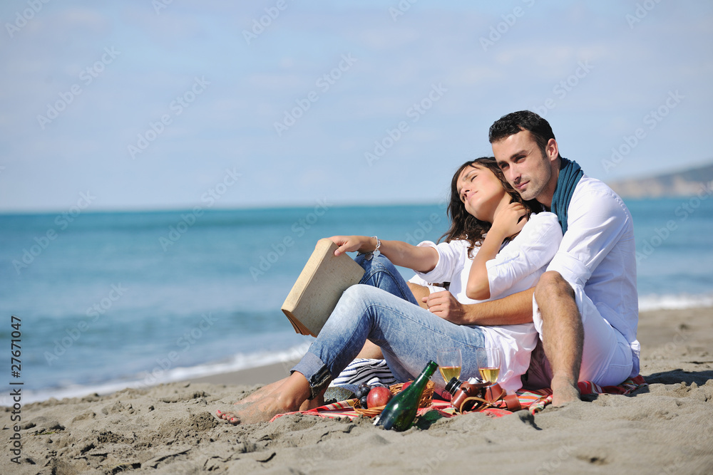 young couple enjoying  picnic on the beach