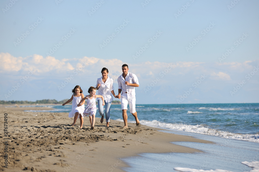happy young family have fun on beach happy young family have fun on beach
