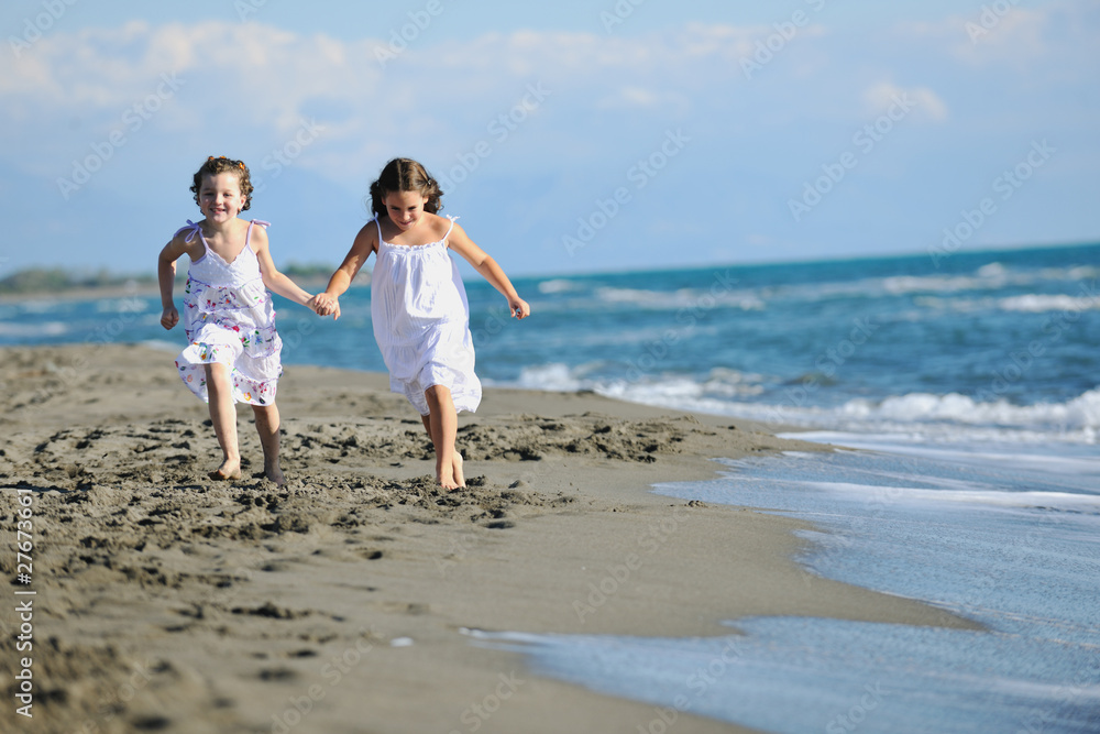 cute little girls running on beach