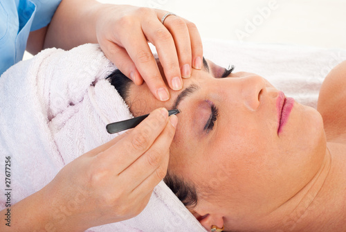 Close up of plucking eyebrows