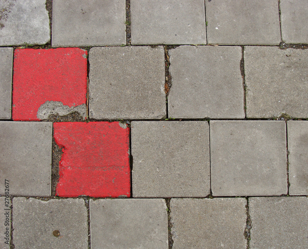 2 red tilesembedded in pavement sidewalk 2 red tilesembedded in pavement sidewalk