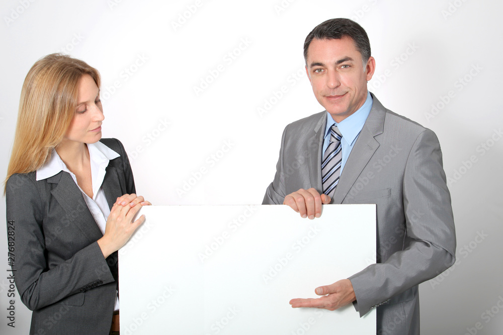 Business team showing white message board Business team showing white message board