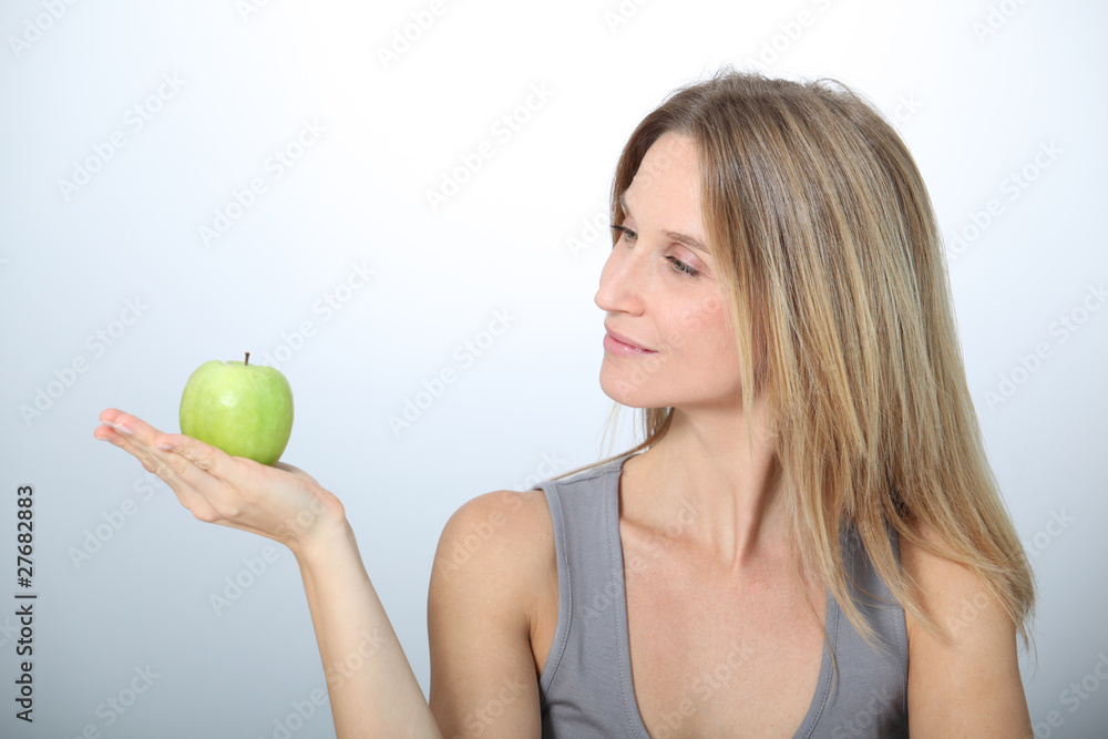 Beautiful blond woman eating green apple Beautiful blond woman eating green apple