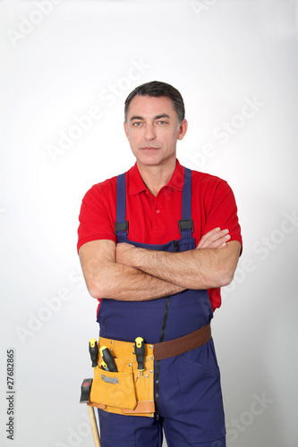 Carpenter with arms crossed on white background