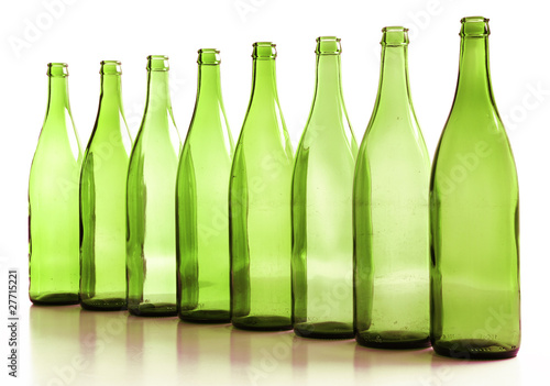 bottiglie verdi vuote in fila, tute su fondo bianco