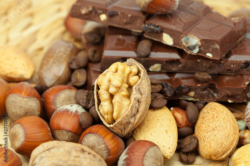 bar of chocolate and nuts on a wicker mat