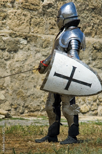Medieval european knight near citadel wall