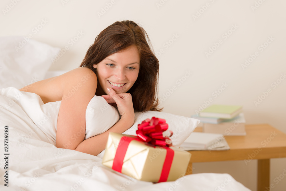 Bedroom surprise present - young happy woman Bedroom surprise present - young happy woman