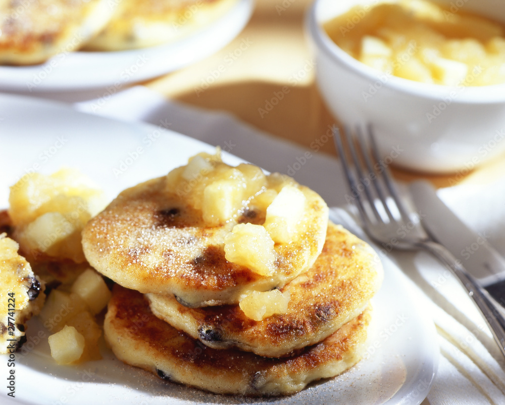 Sweet curd cheese fritters on a plate with flatware Sweet curd cheese fritters on a plate with flatware