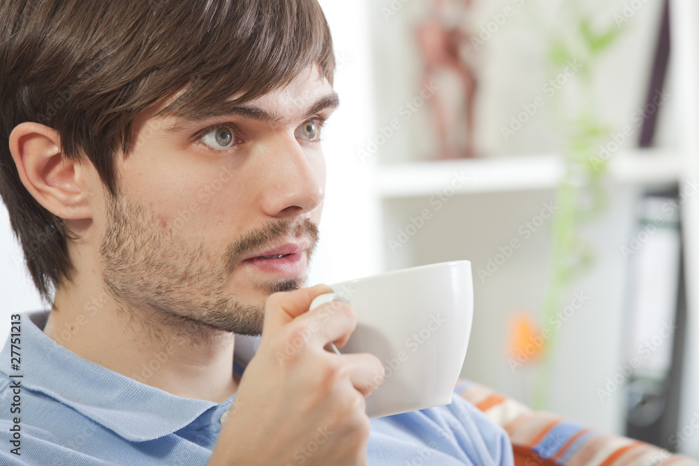 man drinking tea and watching television man drinking tea and watching television