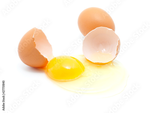 brown eggs on a white background. One egg is broken.