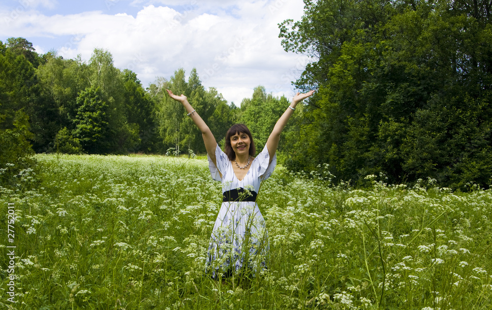 Young woman in white dress on meadow in blossom Young woman in white dress on meadow in blossom