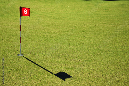 Fotografie Flag and Flagstick on a Golf Course Practive Green