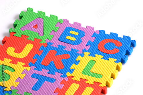 Alphabet puzzle pieces on white background