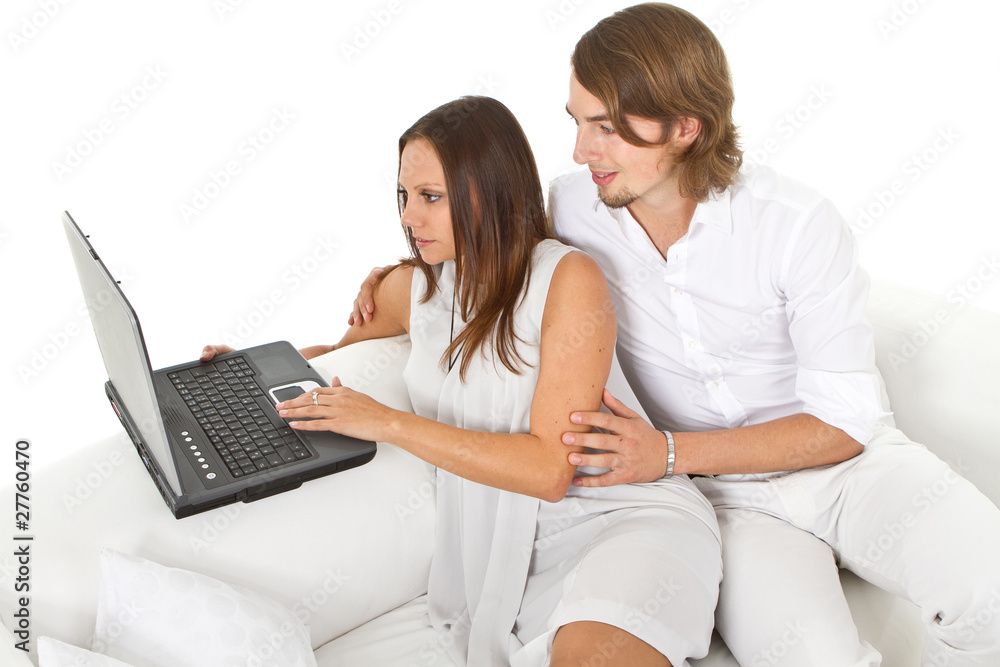 Young european couple surfing the web at home