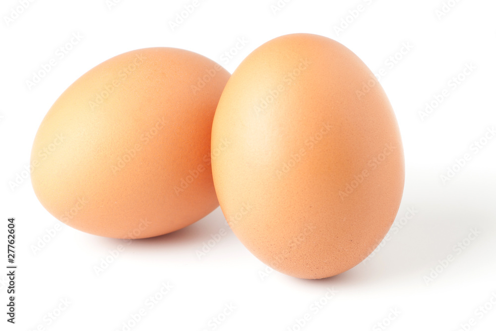 Two brown eggs isolated on white background