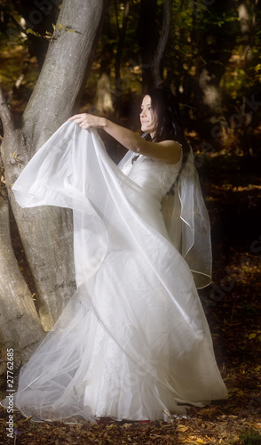 Beautiful bride in fairy tale forest