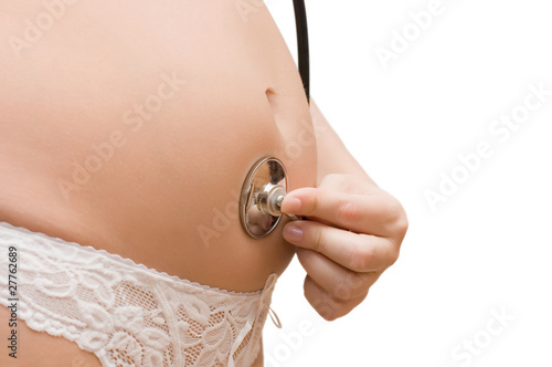 The pregnant woman listens to palpitation of the child