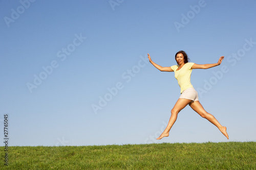 Young woman jumping in air