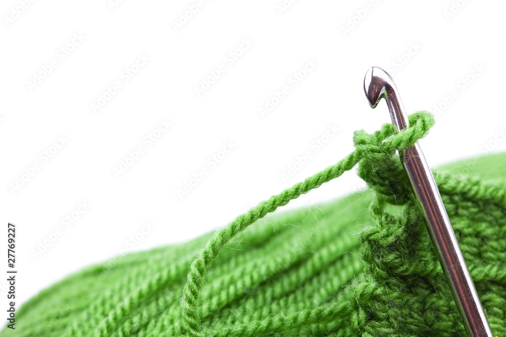 Obraz premium Skein of wool, crochet hook and knitted piece isolated on white