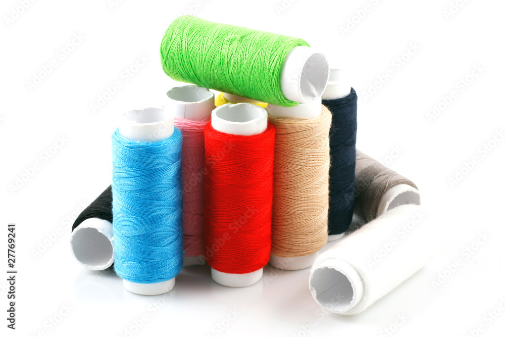 Set of colorful spools of thread isolated on white background