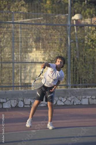 Boy plays tennis