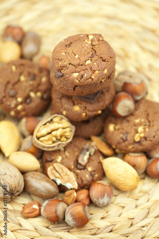 oatmeal cookies, chocolate and nuts on a wicker mat oatmeal cookies, chocolate and nuts on a wicker mat