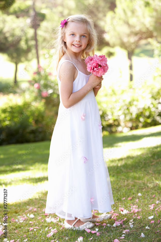 Portrait Of Bridesmaid Holding Bouquet Outdoors