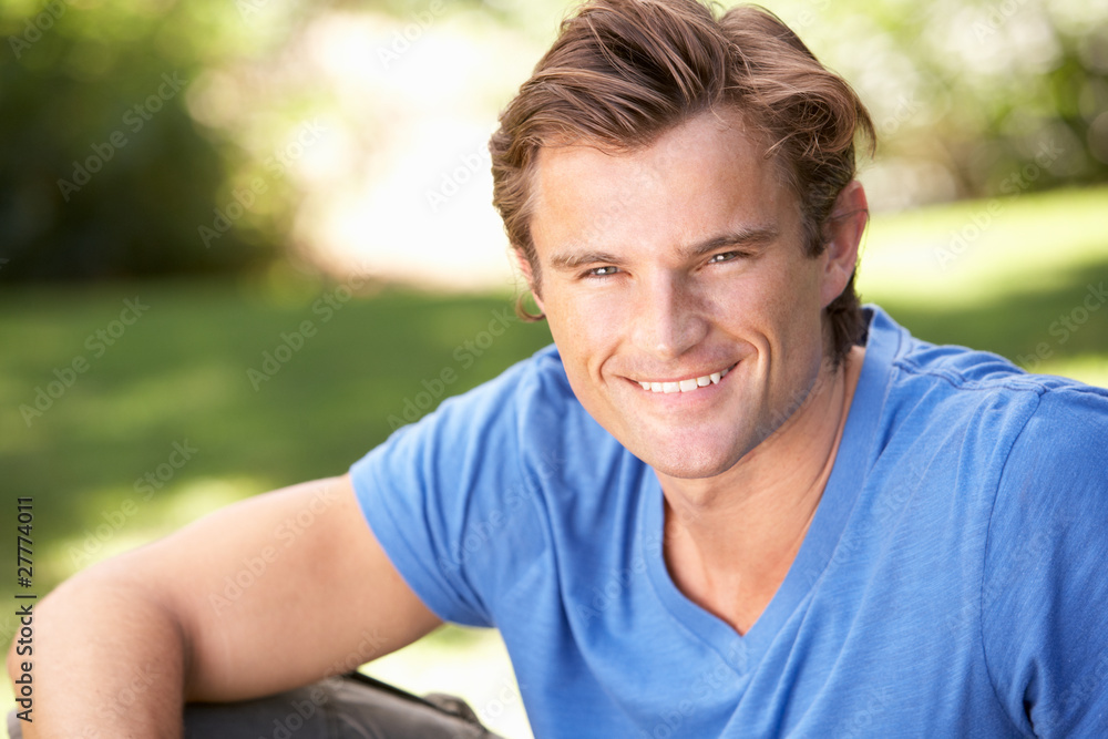 Portrait Of Young Man Relaxing In Park Portrait Of Young Man Relaxing In Park