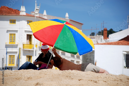 multicolored umbrella on  beach © Inna Felker