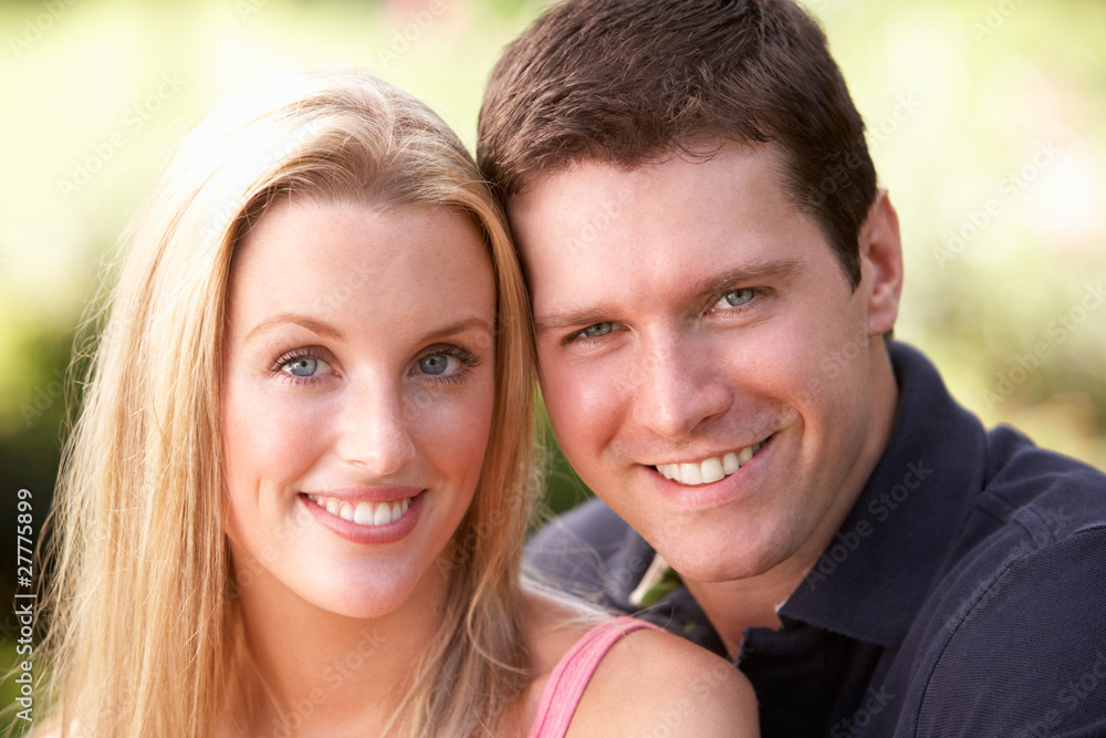 Portrait Of Young Couple Relaxing In Park Portrait Of Young Couple Relaxing In Park