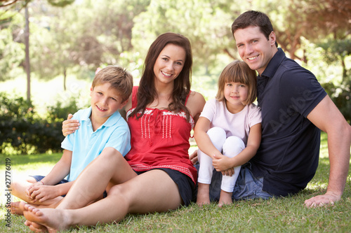Portrait Of Young Family Relaxing In Park